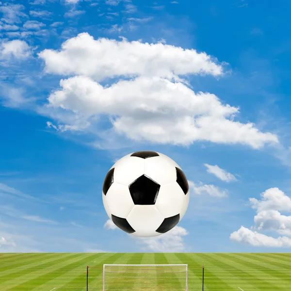 Soccer ball with soccer field against  blue sky background — Stock Photo, Image