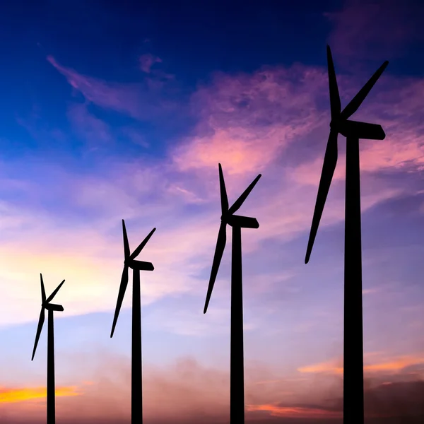 Wind turbine silhouette on colorful sunset — Stock Photo, Image