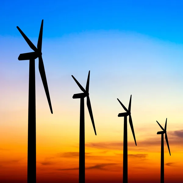 Wind turbine silhouette on colorful sunset — Stock Photo, Image