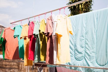 Dry clothes in the air with sun light clipart