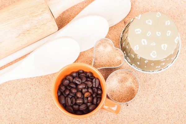 Cup of coffee bean and bakery equipment on table — Stock Photo, Image