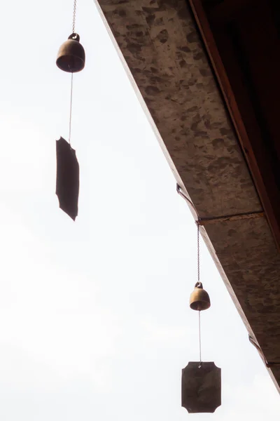 Small wind bell hang on eaves with white background — Stock Photo, Image