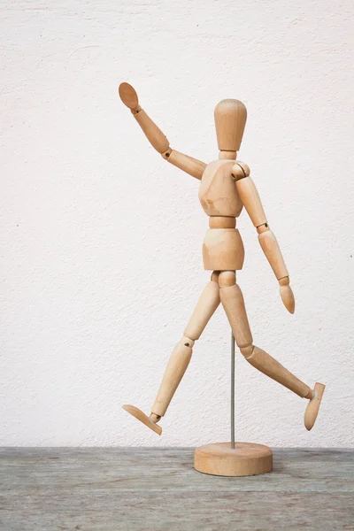 Wooden figure pose as happy jumping forward — Stock Photo, Image