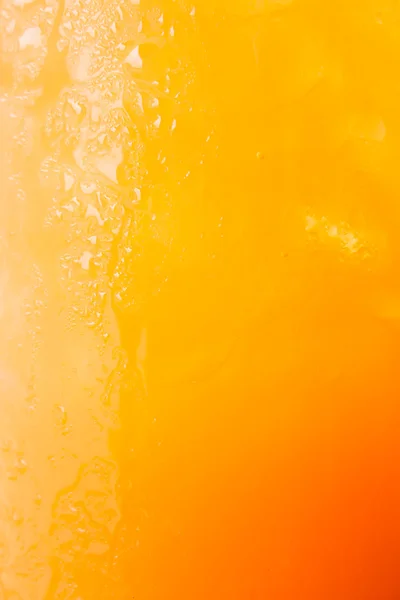 Fizzy glass of iced orange juice up close — Stock Photo, Image