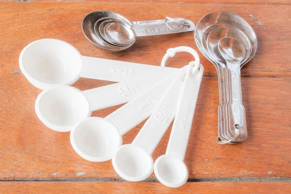 Many types of bakery measuring spoons on wood table — Stock Photo, Image