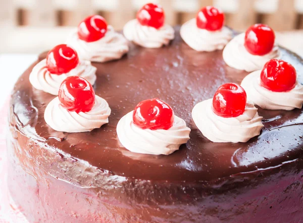Chocolate whipped cream and red cherry on top — Stock Photo, Image