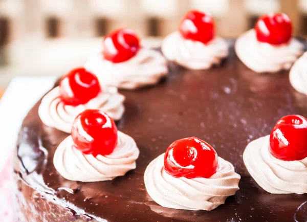 Close up chocolate cake with cherry and whipped cream — Stock Photo, Image