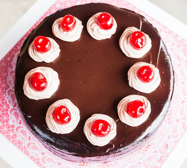 Chocolate cake with whipped cream and cherry — Stock Photo, Image