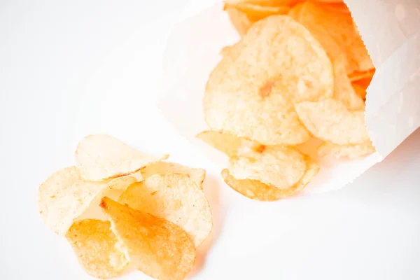 Potato chips snack falling out of the bag — Stock Photo, Image
