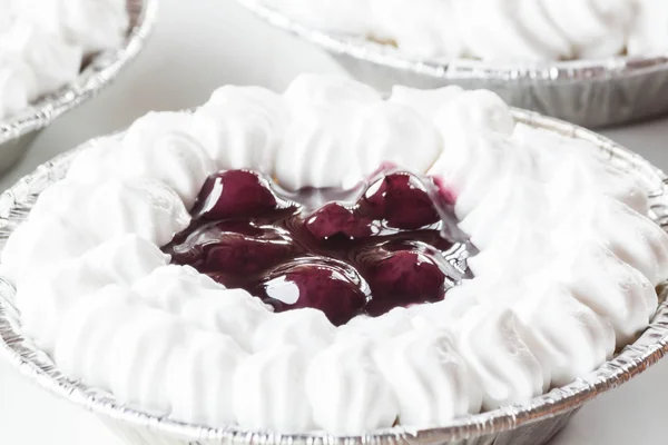 Cupcake of cheesecake topped with blueberries and whipped cream — Stock Photo, Image