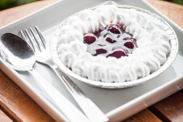 Blueberries sauce cheesecake serving on white plate — Stock Photo, Image