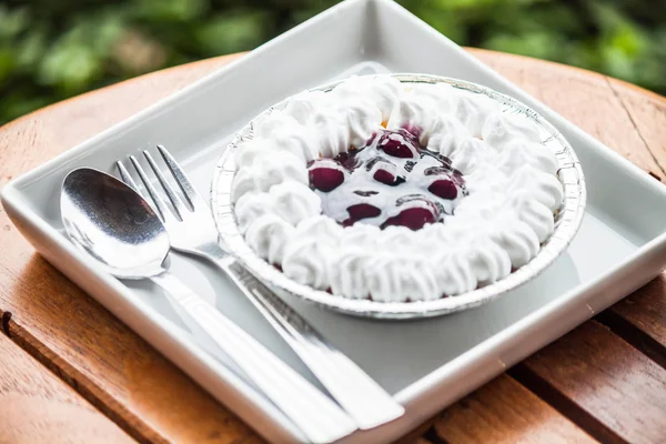 Cheesecake with blueberries sauce serving on white plate — Stock Photo, Image