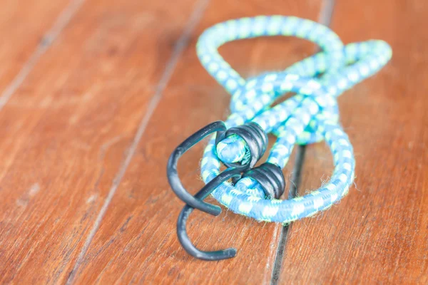 Light blue elastic rope with metal hooks — Stock Photo, Image