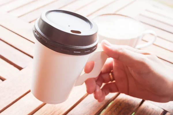 Горячий кофе в бумажной чашке, подается в кафе — стоковое фото