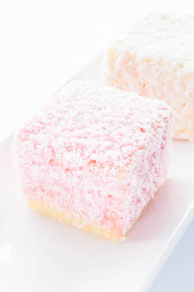 Lamington sponge cakes on white plate — Stock Photo, Image