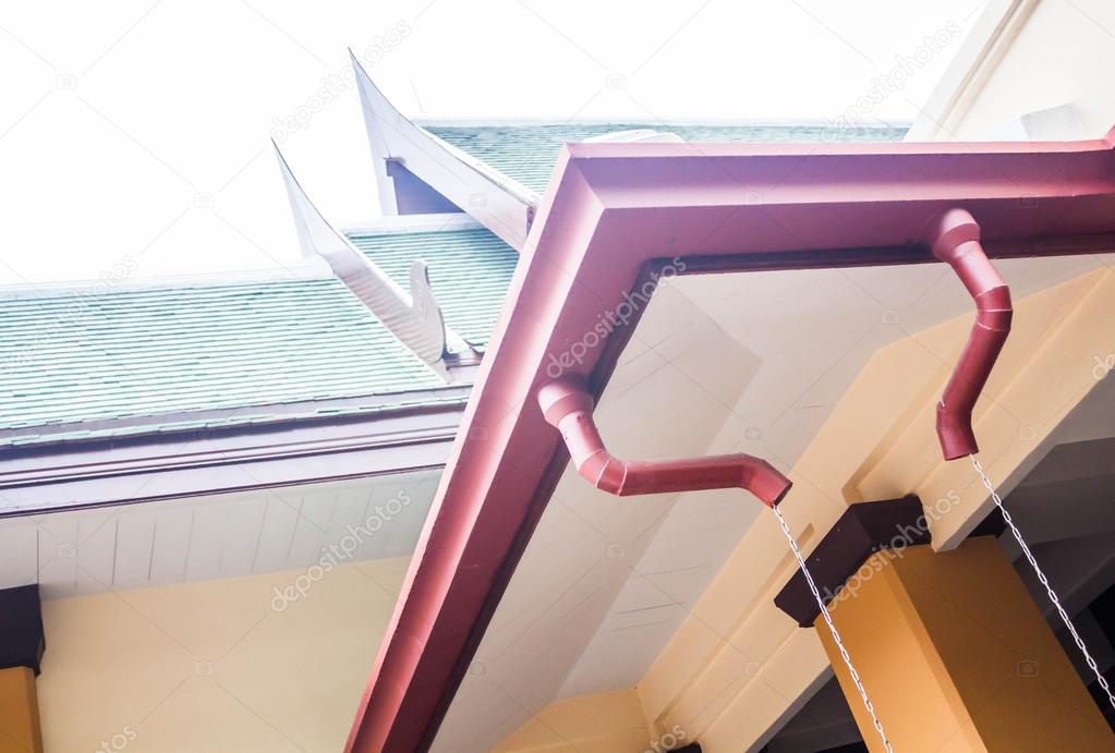 Rain gutters of old style building with sky background