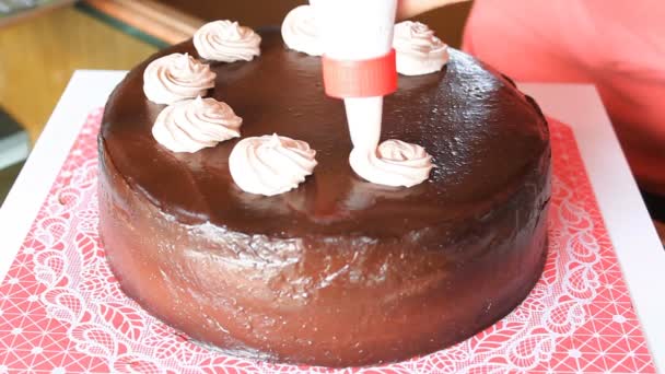 Step of whipped cream topping on chocolate cake — Stock Video