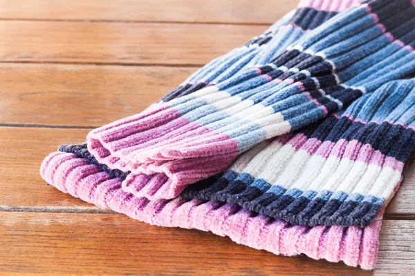 Close up knit wool scarf on wood table — Stock Photo, Image