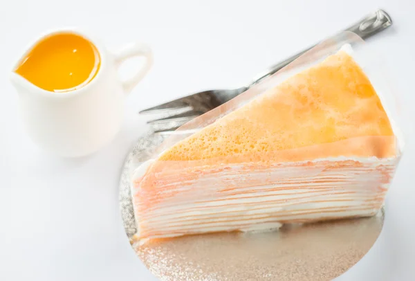 Bolo de crepe com molho de laranja no fundo branco — Fotografia de Stock