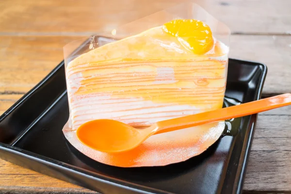 Delicious fresh orange crepe cake with sauce — Stock Photo, Image
