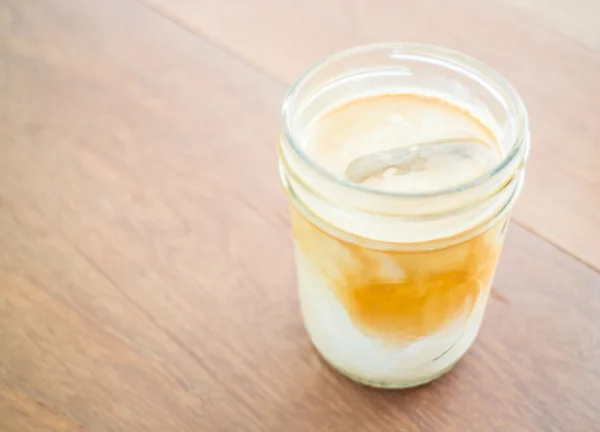 Cold coffee latte with ice in glass — Stock Photo, Image