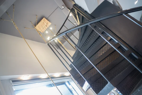 Interior metal dark spiral staircase — Stock Photo, Image