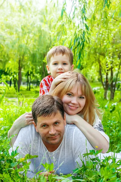 Famille souriante heureuse dans un parc — Photo