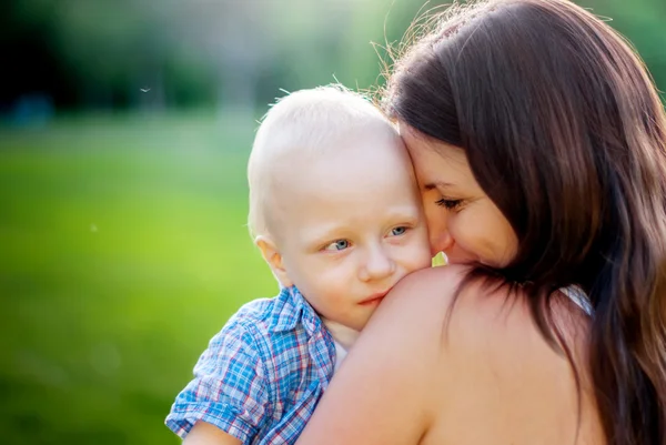 Young Mother and her little son on a nature background — Stock Photo, Image