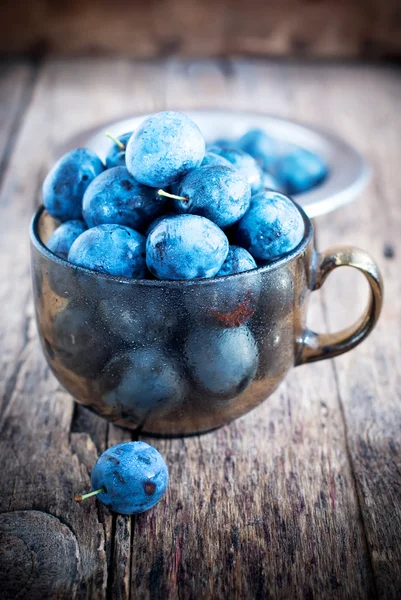 Plums Berries on the wooden background