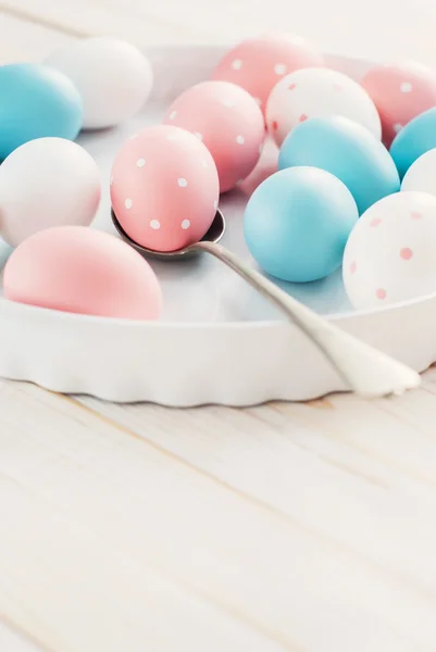 Eggs painted pastel colors and peas — Stock Photo, Image