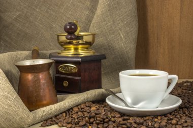 Mermer masa, el-değirmen ve cezve bir fincan kahve