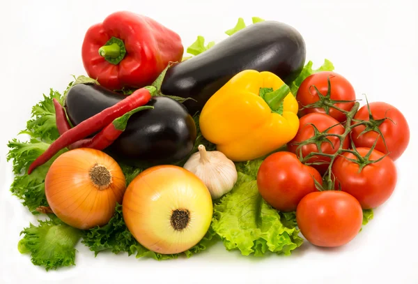 Colorful vegetables lie on salad leaves — Stock Photo, Image
