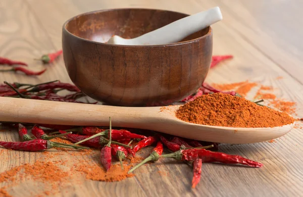 Red hot pepper chili powder in a mortar and pods — Stock Photo, Image