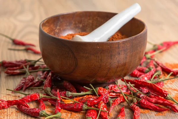 Red hot pepper chili powder in a mortar and pods — Stock Photo, Image