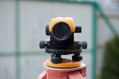 İnşaat binasında tripodla ekipman seviyesinde ölçüm yapılıyor.