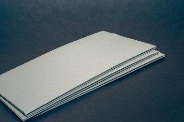 Siyah düz arka planda gri, gümüş bir zarf. Lüks bir şirket kimliği ve üzerinde 
