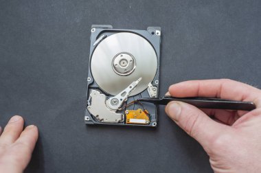 Mühendis bozuk bilgisayar sabit diskini tamir ediyor. Elektronik tamir atölyesi, teknoloji geliştirme konsepti.