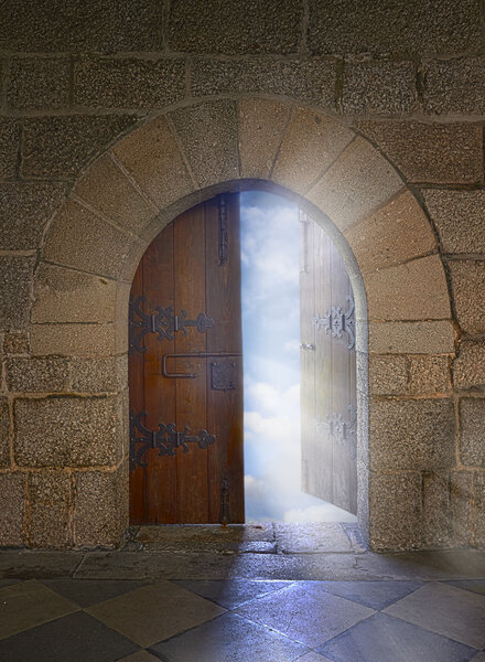 Door with arch opening to a beautiful cloudy sky
