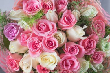 A table decorated with flowers with beautiful dishes, for a date and a solemn dinner. A beautifully decorated horse for explaining love in the garden on valentine's day.