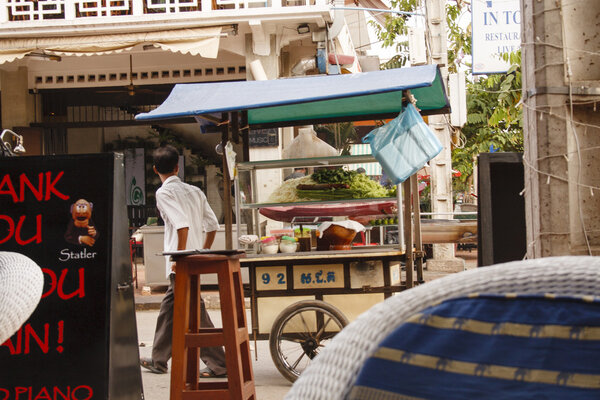 Cambodian man sells food on a street