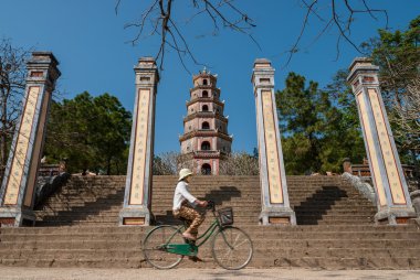 Riding a bicycle in Vietnam clipart