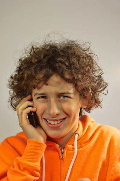 A young boy is talking on a phone — Stock Photo, Image