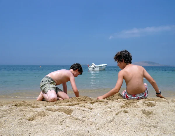 Iki erkek kumsalda oynarken — Stok fotoğraf