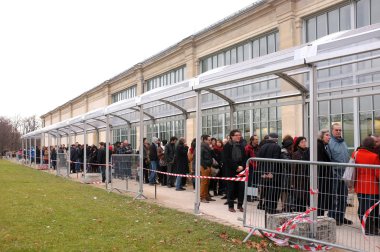 Visitors queue for an exhibition clipart