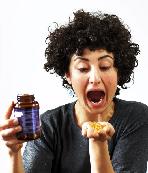 Woman holds pills in her palm — Stock Photo, Image