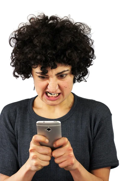 Angry woman looks at her phone — Stock Photo, Image
