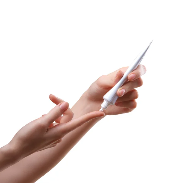 Menina de imagem isolada aplicando creme branco do tubo ao indicador — Fotografia de Stock