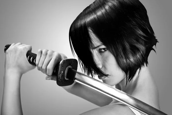 Brunette aux cheveux courts tenant une épée katana — Photo