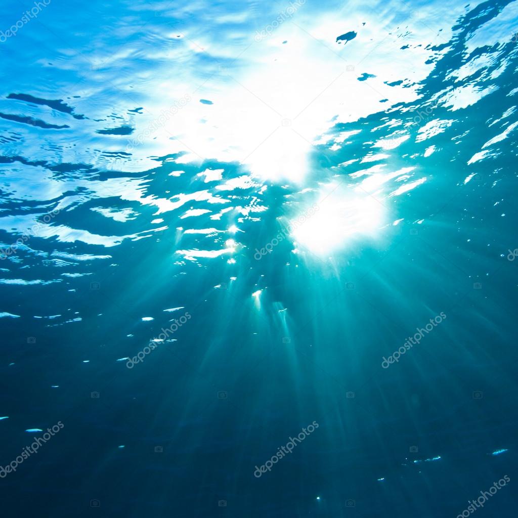 Sunrays breaking through the water surface