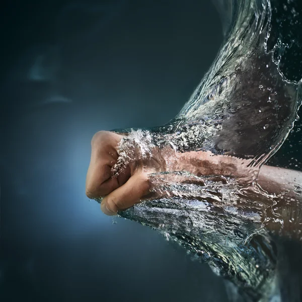 Men's fist punching water splash — Stock Photo, Image